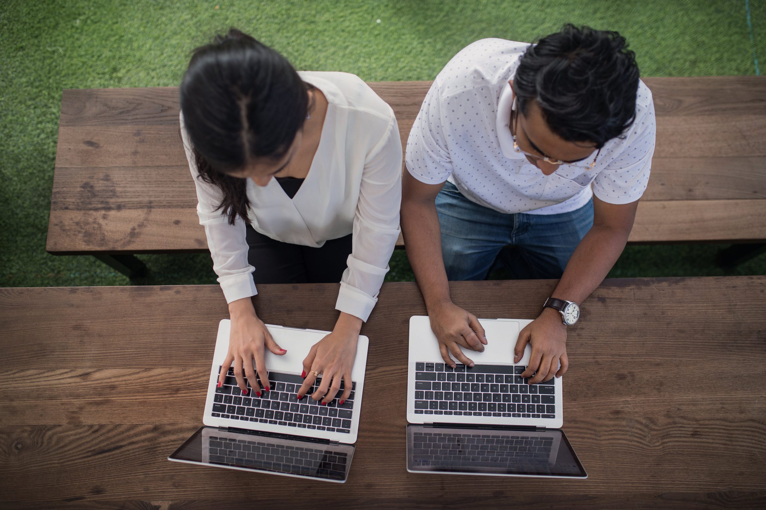 couple cowering on laptops